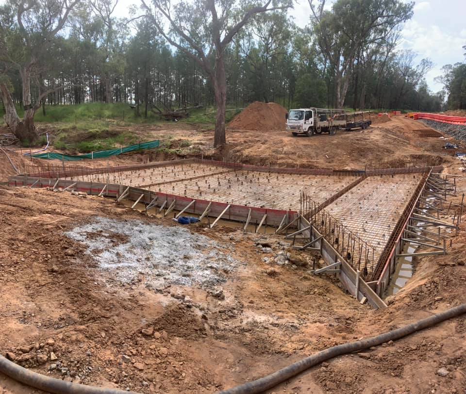 Formed and reinforced footings on a cleared block with gum trees behind