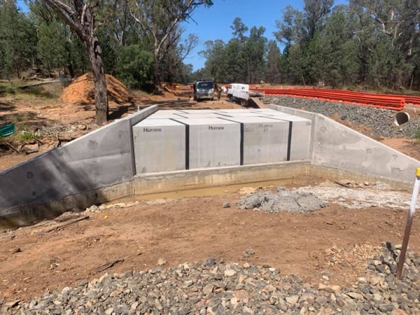 A concrete headwall and box culverts set into a formed channel